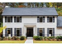 Stunning two-story white brick home with black shutters and a welcoming front porch at 3220 Farmington Se Dr, Atlanta, GA 30339