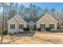 Tan house with green shutters, stone accents, and landscaping at 3639 Fowler Rdg, Douglasville, GA 30135