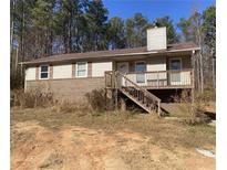 Ranch home with brick and siding exterior, deck, and detached two-car garage at 5234 Maroney Mill Rd, Douglasville, GA 30134