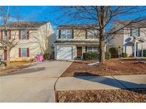 Two-story house with attached garage and landscaping at 444 Kara Ln, Mcdonough, GA 30253