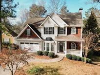 Two-story house with stone accents and a landscaped yard at 9921 Between The Grns, Villa Rica, GA 30180