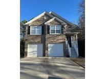 Two-story brick home with a two-car garage and a white front door at 2770 Stony Place Ct, Grayson, GA 30017