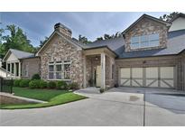 Brick and stone exterior of charming townhome with two-car garage at 4821 Josie Way, Acworth, GA 30101