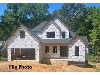 New construction home exterior; two-story home with gray shingle roof and attached garage at 321 Evie Ln, Canton, GA 30115