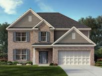 Two-story brick home with gray siding, 2-car garage, and landscaped lawn at 4090 Newburn Ct, Cumming, GA 30028