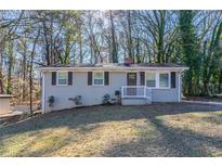 Charming ranch home with gray brick exterior and a well-manicured lawn at 3578 Adkins Nw Rd, Atlanta, GA 30331