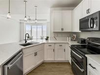 Modern kitchen with white cabinets, stainless steel appliances, and quartz countertops at 400 17Th Nw St # 2419, Atlanta, GA 30363