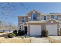 Two-story townhome with two-car garage and landscaped lawn at 314 Oak Leaf Pl, Acworth, GA 30102