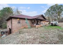 Brick ranch house with a large yard and attached garage at 4055 Thaxton Rd, Atlanta, GA 30349