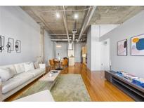 Bright open-concept living room with hardwood floors and modern decor at 1058 Piedmont Ne Ave # 302, Atlanta, GA 30309
