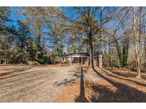 Brick ranch house with covered porch and large yard at 143 Longview Rd, Fayetteville, GA 30214