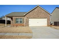 Brick ranch home with attached garage and landscaping at 2646 Calvary Dr, Hampton, GA 30228