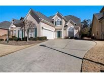 Charming home featuring a long driveway and a two-car garage, complemented by a well-maintained lawn and tasteful landscaping at 133 Wexford Ct, Stockbridge, GA 30281
