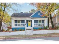 Charming blue house with white trim, front porch, and landscaped yard at 516 Arthur Sw St, Atlanta, GA 30310