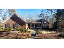 Brick house with gray roof, shutters, and a porch at 1030 Lake Haynes Ne Dr, Conyers, GA 30012