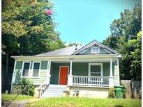 Charming craftsman bungalow with a front porch and a vibrant orange door at 693 Dill Sw Ave, Atlanta, GA 30310