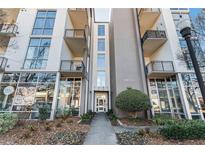 Modern building exterior with attractive landscaping and street-level retail at 3400 Malone Dr # 320, Atlanta, GA 30341