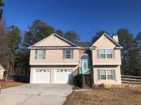 Two-story house featuring a two car garage and a light teal front door at 114 Muirwood Dr, Temple, GA 30179