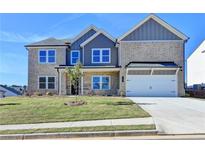 Charming two-story home with a manicured lawn, a two-car garage, and beautiful brick and siding exterior at 57 Longhorn Way, Auburn, GA 30011