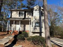 Two-story house with light beige siding, white trim, and a wooden deck at 3725 Linwood Way, Snellville, GA 30039