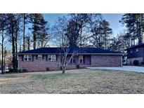 Brick ranch house with a large front yard and mature trees at 4129 Shorter Way, Decatur, GA 30034