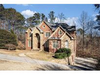 Brick two-story house with stone accents, driveway, and landscaping at 4938 Kanawha Blf, Stone Mountain, GA 30087