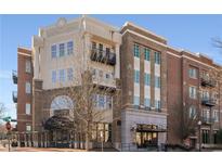 Luxury condo building with brick facade and inviting entryway at 58 Canton St # 303, Alpharetta, GA 30009