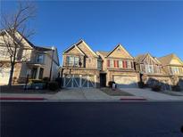 Townhouse exterior, brick front, two-car garage, and well-manicured lawn at 1622 Marsanne Nw Ter # 26, Kennesaw, GA 30152