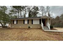 Tan brick ranch house with a covered entry and small front yard at 3770 Larkspur Ter, Decatur, GA 30032