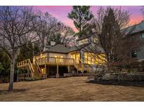 Expansive backyard featuring a multi-tiered wooden deck, providing ample outdoor living space and serene sunset views at 490 Rock Springs Ne Rd, Atlanta, GA 30324