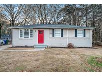 Charming ranch home with red front door and well-maintained lawn at 3355 Renault Se Rd, Atlanta, GA 30354