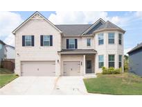 Charming two-story brick home with a well-manicured lawn and a three-car garage at 4783 Sultana Sw Way, Atlanta, GA 30331