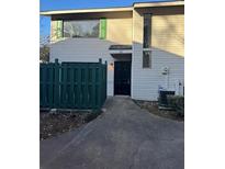 Inviting exterior of a townhome featuring a black door and green fence at 7560 Taylor Rd # 22, Riverdale, GA 30274