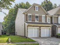 Two-story townhome with a two-car garage and landscaped lawn at 1805 Waterside Nw Dr # 7, Kennesaw, GA 30152