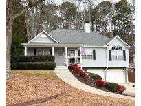 Gray sided house with two car garage, landscaped yard, and walkway at 213 Moore Valley Way, Canton, GA 30115