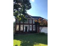 Brick two-story house with a landscaped lawn at 205 Glenbrook Ln, Canton, GA 30115