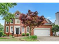 Charming two-story brick home with landscaped front yard, two-car garage, and beautiful curb appeal at 205 Glenbrook Ln, Canton, GA 30115