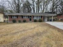 Brick ranch house with carport and a yard at 3445 Mell Pl, Clarkston, GA 30021