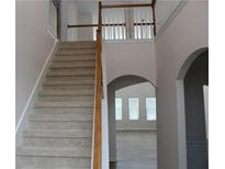 Elegant staircase with carpet runner and wooden railings leading to upper level at 1238 Polk Xing, Mcdonough, GA 30252