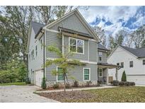 Two-story gray house with a stone base, two-car garage, and front porch at 2362 Browns Mill Se Rd, Atlanta, GA 30315