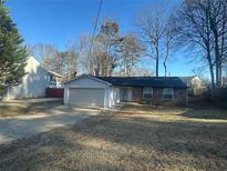 Ranch-style home with attached garage and a spacious yard at 4626 Midridge Dr, Norcross, GA 30093