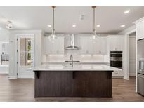 Modern kitchen with white cabinets, large island, and stainless steel appliances at 507 Pearl St, Cumming, GA 30040