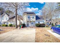 Tan two-story townhome with front yard and driveway at 5908 Trent Walk Dr, Lithonia, GA 30038