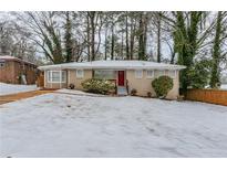 Brick ranch home with a snow-covered yard at 3426 Glensford Dr, Decatur, GA 30032