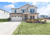 Two-story house with stone accents and a landscaped lawn at 4749 Billow Sw Way, Mableton, GA 30126