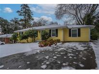 Ranch style home with snow covered yard at 3211 Sandusky Dr, Decatur, GA 30032