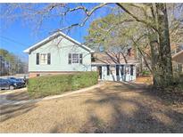 Ranch style home with brick and light green siding, situated on a landscaped lot at 1330 Hillcrest Dr, Sugar Hill, GA 30518