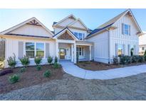 Two story home with white siding, gray shutters, and a covered porch at 5470 Crow Dr, Cumming, GA 30041