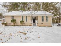 Ranch style home with snow covered yard at 6695 Buckhurst Trl, Atlanta, GA 30349