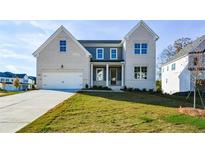 Two-story house with white brick and gray siding, featuring a front porch and attached two-car garage at 5435 Crestline View Rd, Cumming, GA 30028